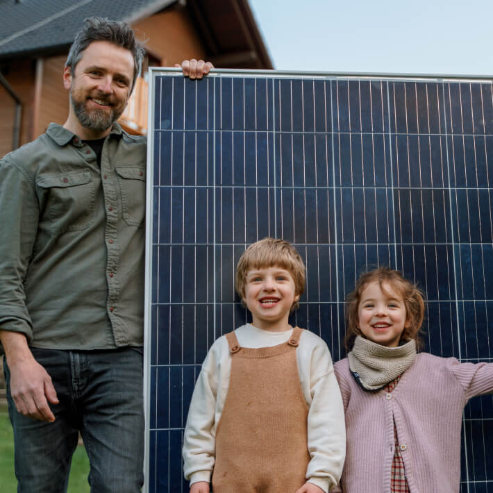 Vater mit Kindern und einem Großen Solarpanel
